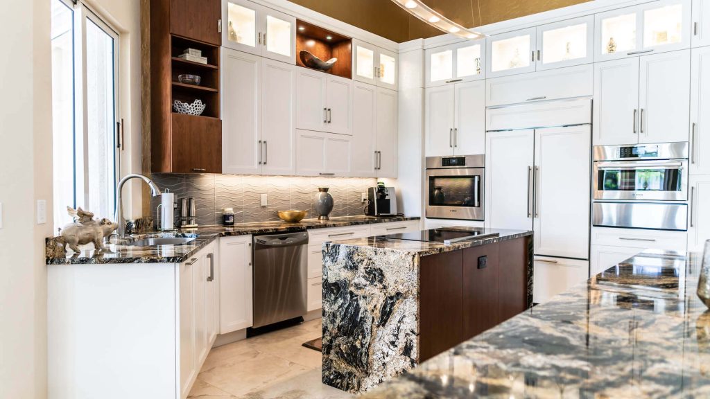 Naples condo kitchen with walnut island and exotic stone waterfall counter